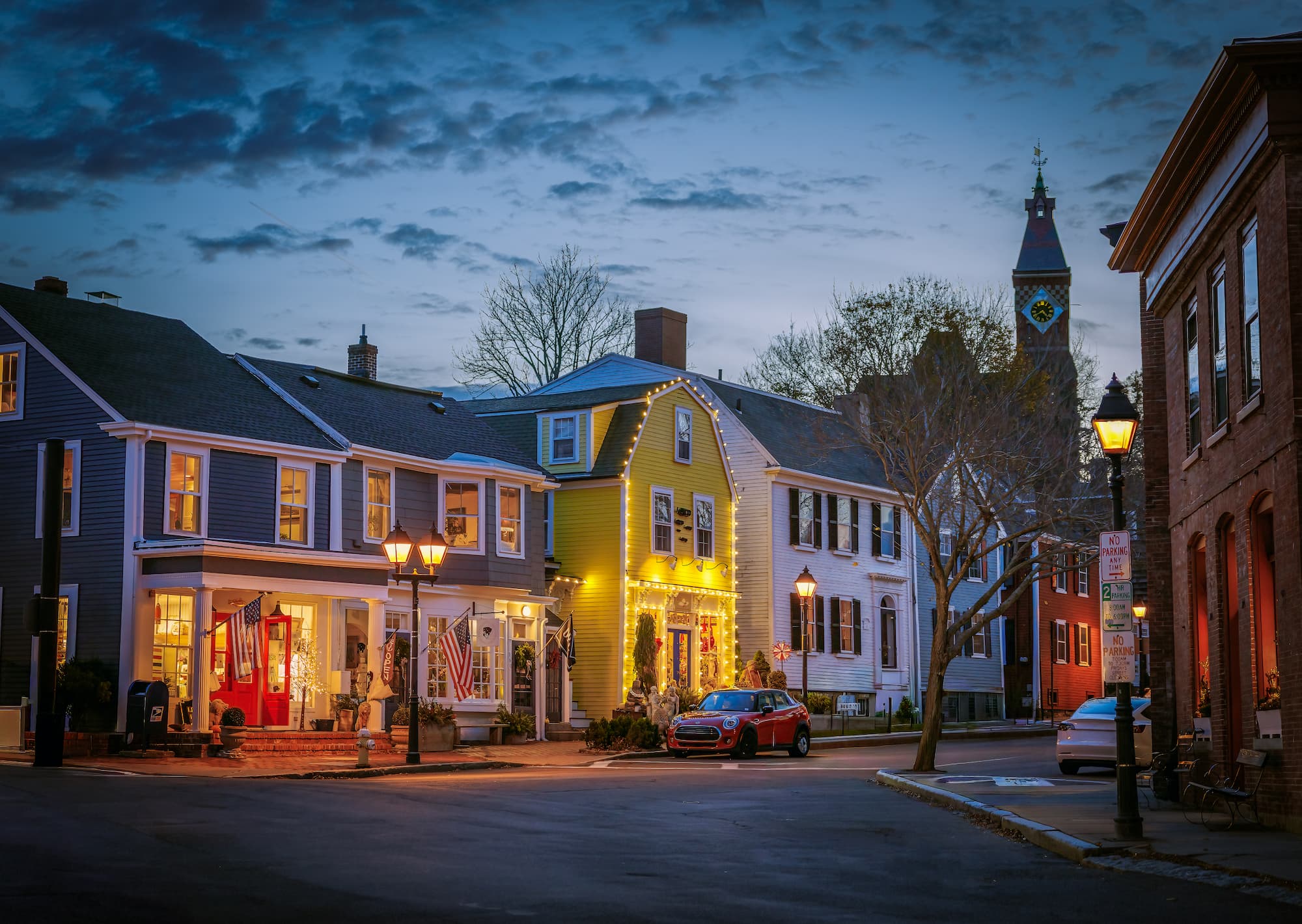 Historic Marblehead streets at dusk — lantern-lit colonial buildings in Old Town
