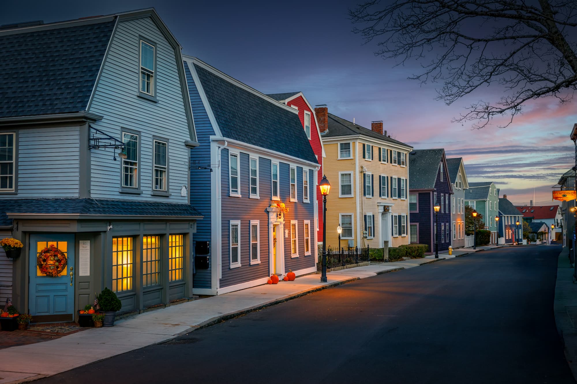 Historic Marblehead street at dusk with pumpkins and lanterns